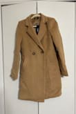 The coat isn't nearly as tailored as the picture looks. It is an oversized fit and looks really frumpy. The color is not as pictured. The quality was not great, either. You can see that the sleeves are a bit uneven as is the bottom of the coat. And the shoulder seams have a weird, uneven structure to them, almost like a mini shoulder pad with a very thick, bulky seam. I generally have great luck with Lulus and order regularly but this coat was just bad. I would absolutely return this coat if I could, unfortunately it was a final sale when I purchased it. - Christine D.