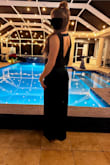 I am so in love with this dress! I scooped it up during the Black Friday sale. I am a pretty standard size small, petite but athletic. I ordered S originally, and it was much too big both through the body and the top. I quickly initiated the exchange and they had the XS in my hands 3 days later! Which gave me time to have it hemmed (super duper long, even in 4 inch heels), and had the slit made higher at the same time. The dress is soft, stretchy, and falls so beautifully. The emerald color is exactly as pictured. I love the open back & the slit was so sexy! - Steph O.