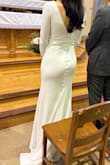 I bought this dress less than 3 weeks before our winter church wedding with 12 guests. It arrived within the week, and I had alterations done right away. I have a very muscular build, and I needed the shoulders and hips altered. I also had the seam taken in under my butt slightly to accentuate it. At 5'7 in 2" heels, I didn't need to shorten the dress, so keep that in mind if you're tall. I wish I had ordered the XS instead of the S based on the alterations I had to do, but it's what the website recommended. The dress took about an hour to steam, but it didn't wrinkle again easily. The silhouette and fit were fantastic, and the dress was comfortable to wear. I wore a sticky bra, which was perfect with how the bust was sewn. I had to buy shapewear to find underwear with a band up by my ribs. It was a thong style and only showed slightly. I got a lot of compliments, and no one believed the cost. Super happy with the purchase, and I'll need to keep doing squats until we shoot our second look. - Alanna B.
