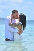 Wore this dress for my wedding in St. Lucia and it was absolutely perfect. The dress was not as heavy as some people described in the reviews and it was true to size. I "trashed the dress" by jumping in the ocean and it was not see through!! Amazing dress and I got so many compliments. - Linnette H.