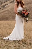 Ordered and wore this for my wedding in January 2026. This dress is simple and clean and was very flattering on my body. I have an athletic frame and felt very feminine in this dress. I did have the straps altered to eliminate the adjustable clip, because I thought they make the dress look cheap. I am very tall (6'0) and the dress was long enough for me, hooray!! The buttons along the back definitely give this dress a higher-end feel. Very very happy with this dress. - Abigail R.