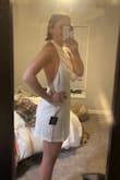 I'm so excited to wear this on my Bach party and my honeymoon. I got a size medium, and yes, it can be low in the chest, but I am getting clothing tape so it stays in place! So cute with heels. - Kathleen G.