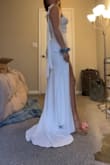 This dress is so flattering!! I did have to get it hemmed since I'm 5'3, but I expected that from any dress. The slit is perfect, the bust is flattering, and I love the little train! The tie straps are perfect for adjusting, and they're also beautiful. The fabric has some stretch, which is also nice, since I'm usually in between sizes S-M, but lean toward S. The S fits perfect and the stretch adds room for comfort and dancing. I was looking for a budget-friendly dress, and I found it! I am so excited to be wearing this for my wedding. - Jayda H.