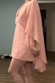 I really like this soft pink minidress. It's got a dreamy, sexy, 1970s vibe with a cape that extends past the dress. I plan to wear it for a birthday night out. The fabric is soft and crepe-y fabric. The fit is relaxed. The top is quite open so bear that in mind if you have a larger bust; it may be difficult to find the right bra to wear with the dress. Overall, I'm very happy with the dress! - Rachel L.