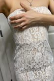 There's a corset built into just the top half above the waist, but it does not sit flat and looks like there's a fold in the dress. Even with trying to alter the dress, it's still sticking out. Not flattering at all, really disappointed - Nicolletta C.