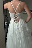 This dress is really pretty! I decided not to keep it just because the style isn't what I want anymore. The quality of the dress and materials is nice. The corset back allows you to easily tighten and adjust the bust and straps. I'm 5'4 and ordered the XS. It was a bit long and big on me, but I could see it being easy to alter. The top is pretty sheer, but I don't think a bra is needed, though there isn't much support, so you might want to add or wear something underneath, depending on how much cleavage you want. - Emily H.