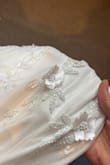 Bought this for my wedding. I went for a medium so I would have room for alterations, but it really only needs a tiny bit on the waist and the straps taking up. There's a lovely weight to the fabric, but it still feels light and wearable. The back isn't too low, so you could still wear a Skims bodysuit. - Iona B.