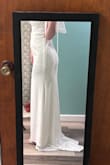 I like it, but I'm not sure I LOVE it. It's a nice dress for the price. The material is decent, has some weight to it without being hot and heavy and the back button details are beautiful. Im not a huge fan of the breast area and lack of support. Definitely need to sew in padding or find a supportive strapless bra. I'm 150 lbs and 5'8, usually go for a size 8 dress or large, but decided to get a medium and it does fit which is great! But the lower waist area is a little loose so I would have that altered to have a more fitted look. The fabric does have stretch to it. I was able to slip the dress on and do the zipper on my own which is a plus, too. Again, its not BAD. Maybe after alterations I'll feel a little more excited about it. I did add a bridal belt (not pictured) and it definitely pulled it together more, giving it more glam. - Amy C.