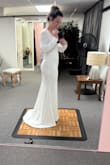 Bought this dress for my elopement, and I am so happy with it! These photos are from my alteration appointment, so you can see the pins in it. I am 140 lbs, 5'2", wider set on the bottom half (THICK BOOTY AND LEGS). I am wearing heels in this picture to have the dress altered to the right length. I originally bought a medium, but it was much too big on the top. The small fit is absolutely perfect except for the length, but that is always a given for me because I am short. It is labeled as a mermaid but did not really have that shape on my body, which I am really happy about because I am not a fan of the mermaid look. Small train, which I love. Tough to find the right underwear that doesn't show line imprints on my body because the dress is form fitting at my hips, so I bought Spanx that go just below the bust, and they worked great. No bras, just cakes nipple covers. Cannot say enough great things about this dress, and so happy with my purchase! - Emmy B.