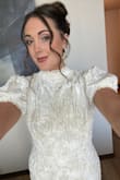 This dress is stunning. Fits great with plenty of give (if needed). I have a smaller bust, so that was the only part of the dress that could have fit tighter. I wore this to go wedding dress shopping and felt amazing. I got compliments all day! - Delaney S.