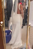 I decided to have a last minute courthouse wedding. Shipping was super fast, and I didn't have to make any alterations! I am 5'0, but the length was perfect with 4.5 inch heels. My mom was shocked at how beautiful the texture of the dress is. I did size down based on previous reviews. The main downfall was that the straps were very long, so they kept slipping off. They stayed in place with double-sided body tape. Also, there were gaps along the portion of the dress that falls against the ribs because of the backless nature. Nothing more tape didn't fix. - Aileen H.