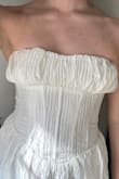 There is no cupping or anything to hold the fabric up in the bra area, so it slides down and mushrooms over the boning. - Hannah G.