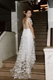 My wife wanted something that felt like her for our wedding day. This jumpsuit had the right amount of structure, but the floral detail made it very fun. The best part was the open back and beautiful train. It made her feel very bridal without having to wear a dress. - Courtney B.
