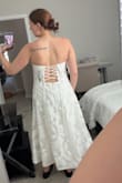 It felt a little more stiff than I expected it to. I guess there is boning in it, but the picture makes it look more flowly. Just didn't sit right on my body - Ibby B.