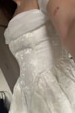 I ordered this dress for my tea party-themed bridal shower after eyeing it on the website for months, trying to find an excuse to buy it for one of the many bridal events. The dress pattern is beautiful, really detailed. There is some stretch to the material. Even though the sizing was a little large on me (not enough to size down), I did struggle with the zipper on one spot of the track, so just a heads up that zipping up can be a one person job, but is probably easier with a buddy since it's a side zipper. - Tara O.
