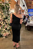 The dress fit beautifully. Although it was form-fitting, it did not cling in any unflattering areas, creating a smooth and streamlined silhouette through the midsection. The cross-shoulder neckline was particularly flattering and added an elegant touch. As someone taller, dress length is often a concern. However, this piece exceeded expectations, falling at an ideal point along the calf. - Ashley