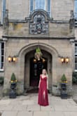 I wore this to a wedding in Scotland at a castle and it looked like a fairy tale! I got a Medium because of my bust and I am so glad I did. Despite my small waist it was still a great fit, although I did have the straps taken up and of course had it hemmed because I am short. I got so many compliments and have never felt so beautiful. It is so high quality and just a stunning dress. The rich wine red color was amazing. This is my favorite dress of all time and I just need to find another reason to wear it!!! - Mariah F.