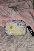Am disappointed in the version I got. In the picture, it is mostly teal and bright colors with a little bit of the white flower. The one that arrived, the flower is in the center, so the bag is mostly white, and the black sequins that are just supposed to be an outline overwhelm any other colors, and the purple is more prominent than the teal. I guess each one is manufactured differently, but this is enough of a difference that I will probably end up donating it. - Katherine Z.