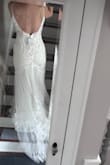 It was beautiful and had a great train and lace detailing, but the bust was stiff, and I didn't fill it out well enough for it to be comfortable. Felt very high quality for the price! - Erin H.