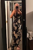 I had my eye on this dress for quite sometime, but not a big fan of ruffles or flowers. I'm a little more simplistic. I saw that it was on sale for $44 from $110, so thought what do I have to lose? It is a little snug around the ribcage as others have said, but not enough to be uncomfortable. Also being short, it is too long even with the heels. I am having it shortened. Can't wait to wear it, even though it's out my comfort zone, it's really a beautiful dress. - Juneeta F.