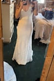 I ordered this as an option for my wedding dress and fell in LOVE with the silhouette. The straps were too long on my shoulders, but that is true always for me because I'm so short. 

The neckline is kinda weird, and the fabric is a good bit see through below the bodice. 

The fake buttons also look very cheap 

For 180, a total steal - Bethany K.