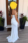 This dress was stunning. I purchased it from Prom, and I did not have to get it altered at all. I wore 3 inch heels, and it was the perfect length. I wear size 0/2 and ordered XS. The fabric has a little stretch to it, and with the corset closure in the back, it makes it really easy to get the perfect fit by adjusting the ties in the back. - Janell N.