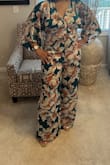 I purchased this jumpsuit in both a small and a medium because I wasn't sure about the sizing after reading the reviews, and I've recently gained some weight. The small ended up fitting perfectly, while the medium was too big. The only issue was that the button on the back was missing, but customer service was very helpful when I reached out. Overall, the jumpsuit is cute and comfortable. I wore it to a sweet quinceañera and received lots of compliments. - Teunille W.