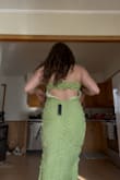 The material is stretchy and thick. The back is loose and fits weird. I had to get mine tailored to fit my back. - Paige P.
