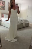 Purchased this dress for my upcoming wedding, and it is absolutely stunning. I am approximately 135 pounds and wear a size small. Being a short girl at 5'3", the length is definitely way too long. I do find the dress very bottom heavy, and it frequently shifts down. But having got the dress at a steal of $75, I can certainly afford to have it altered to fit perfectly. I'm going to have it shortened, install a waist stay/seatbelt to prevent falling down, and a bustle in the back for the reception. Overall, the dress is stunning, and I hope that the alterations make it absolutely perfect for my wedding day. - Candi M.