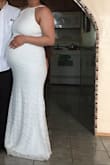 I'm 9 months pregnant, but my stomach is not very big. I ordered this as my wedding dress. It drags a bit but I didn't mind as my feet are super swollen & I didn't want anyone to see. This dress is stunning & it barely fit. A larger size would have been too big I think. The material does stretch & therefore didn't restrict me. Super helpful that the straps are adjustable as well. Overall, very pleased with this dress. - Esmeralda P.