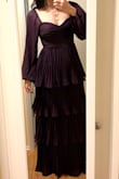 This dress is exactly like the photos! It fits perfectly and the color is so beautiful! I really like how it is tighter at the top and waist and  then opens into the beautiful layer skirt! The fabric is also great! I believe this dress is great to many occasions! I intend to wear it as a wedding guest, but I can see myself using it in the future in many other types of events! Just buy it! You won't regret it! - Carolina R.