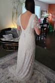 I really loved this dress online and wanted to love it in person, but it was not THE dress for my wedding. The beading was beautiful, but there was some already falling off just with the try on. The quality did not meet the price in my opinion. The deep v front and back was my favorite and was very flattering on me. The sleeves were gorgeous. The dress was surprisingly heavy due to the weight of the beads also. Overall, the dress was very nice, and I would recommend it to someone who wants a more whimsical vibe. - Deidra W.