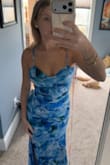 Dress fits true to size and looks just like the photos. Has a bit of stretch to it too so you are comfortable and able to move. Straps are adjustable. Colors are super vibrant and the slit is a perfect height. - Bailey A.