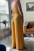 I am 6' tall and was happy when I saw the "too long" reviews from other customers - the length is great on me! I love the flowiness of the pants, which move almost like a skirt when I walk. It would look better on me if my boobs filled the top more, but the straps on the back make it pretty adjustable.

I'm wearing hot pink underwear in the photo, which you really can't see through the fabric even though it's very lightweight. - Melinda M.
