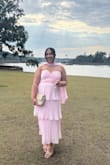 I loved this dress! It fit so perfectly, and I received so many compliments!  Didn't budge much the wheel at night, either considering it is strapless. I had gotten the scarf elsewhere for an extra accessory! - Bryana R.