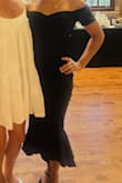 This black dress is incredibly flattering! The flared hem adds the perfect touch of elegance, while the open-shoulder detail with cuffed short arm sleeves gives it such a chic, elevated feel. I wasn't sure if it would at first when taking it out of the package, but it fits like a glove. I typically wear a medium with Lulus and went with the same size here. It enhances your shape in all the right ways! - Ireland J.