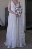 So I really wanted to love this dress. For the price, it felt very romantic and bridal, but it gives a really unflattering silhouette.
I am slender - 5'8" and 130 lbs. But this dress made my ribcage look super wide, and it was a really strange length in the bodice. If the skirt started to poof out a little lower, it may have worked. But my typically long upper body felt really stumpy, and despite my slimmer figure, it made me look like I was pregnant. It gave me the strangest silhouette, and even with alterations, it just didn't work. I spent $300 on alterations, and it didn't look any better. My seamstress also said that it was difficult to alter because of the cheap fabric and the fact that it was built in panels.
So, unless you're willing to spend more on alterations than the dress itself, I would think twice. It runs really large and has a really low neckline, which didn't work for me as a woman with a smaller chest.
And the zipper issue, as many others have noted. - Kelly J.