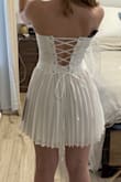 Love love love! Got this for my bachelorette trip. Shows off the curves beautifully and isn't too short but I think would need under shorts or a slip since the pleated skirt is a little see through. The corset is a little smaller on me so I probably should have sized up to a medium but it's perfect. Ties in the back with thicker string so I'm not worried about a rip! Scarf is so cute! - Leah S.