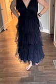 I purchased a dress to go to a wedding and don't want to attract too much attention!  I tried the dress on straight out of the bag and the level of "poof" was a lot! It looks nothing like the review photo which show the detail but it looks streamlined vs. Mine where the outer layer of the mesh/tulle is very puffy and less flattering that pictures as it makes me look much larger!  I'm not sure if it just needs to be hung so the material "falls" after period of time? I'm not sure I want to spend another $100 for a seamstress to cut out a bunch of the Thule but the photo of me in dress has an handful of material clipped behind my back to what I would want it to look like/ hanging dress shows the "volume"
Did I end up with double material or can this be salvaged? Not going to a prom!
Any thoughts? - Kate T.