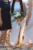 I'm a little thicker in the hips and have a larger booty, so this dress fits a little snug in that area. Unfortunately, the dress did rise, and because of the slit, this made the dress go up higher on my thigh than I would have liked. It was a windy day since we held the ceremony on the beach. I would recommend hemming it a few inches to avoid having to hold it closed like I did while walking down the aisle because of all the wind blowing it open. Other than that, this dress was perfect and served its purpose. I didn't want something too plain, and I feel like this dress did elevate the aesthetic of simple but elegant. Would strongly recommend wearing a slip dress underneath as this was super sheer and it hugs your body and can be a little unflattering if you have a mom tummy like myself. - Gladys B.