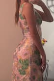 Absolutely loved this dress!! Very, very flattering! It has a beautiful V-cut in the back, and the slit hits the perfect length on the hip (not too revealing, or anything you'd actively need to monitor). The waist is a little tighter than expected, and the material doesn't have any give. However, the cut of the dress has a nice hour-glass figure, so there's more room in the hip/chest areas, so it works well! Overall, loved this dress! - Emma B.