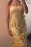 Loveeeee this dress! The flowers have kind of an ombre effect, as they're more dense towards the bottom of the dress than at the top. The dark yellow flowers pair beautifully with the light yellow dress, the colors are exactly as described. The material is stretchy, and has lots of give. Overall, very beautiful and comfortable! - Emma B.