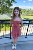 This dress is adorable! The tie straps and back make it super easy to achieve the perfect fit. There is just the right amount of flounce with the layered skirts. It is super easy to wear. Very comfortable. So cute. It's perfect for a summer party, graduation, or dance. - Chaaron P.