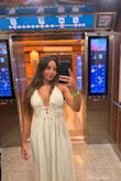 Cute vacation dress was not too long I wore with heels and used breast tape to make sure dress hold up but the halter tie top is also very helpful the shells are so cute and are very secure. The seashell lining is tight and there is a zipper in the back I would say this dress is true to size I'm usually a size small and the zipper fit snug but fit. - Skyla C.