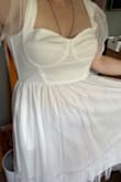 This dress is super cute. It's very girly, cute, but not childish. I felt like a beautiful marshmallow cloud. The chest and the straps fit a bit weird. The straps are slightly too loose, but not loose enough that I could get them tailored. I'm not sure, but they just don't stay up well, and this dress doesn't look cute off the shoulders, so I'll probably have to use some double sided fashion tape when I do wear it to my bachelorette. I love the way it fits, but a little hesitant about the chest. I feel like the way this dress fits, the cup size doesn't make sense. I don't feel like I'm secured enough in the dress to go braless, but with a bra, I feel so tight between the dress being tight and wearing a strapless bra. But I feel like for what you're paying for, those minor tweaks are worth it. This dress is so pretty. It's whimsical and just fun to wear. And not very see through either! I would wear nude undergarments of course, but I've tried on dresses where you can even see those. These have a very nice lining. - Alyssa S.