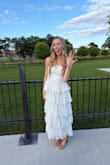 I ordered this dress for my rehearsal dinner, and I was a little scared since there weren't any reviews yet, but I am so glad I took the chance! It was absolutely stunning and fit me perfectly! I love the ruffles and dots as they added such girly features to the dress!! The zipper was a little tricky and kept getting stuck when I put it on, but once it went, it was beautiful! It was also a little longer on me than I expected, but I am on the shorter side (5'3"), and I loved the way it looked regardless! It is double-lined, so it was not see through at all, which is great when shopping for white dresses. - Kami F.