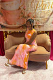 I received so many compliments on this dress. The theme was orange and pink and this dress matched the theme of the tea party with my sisters in Christ. The material is not stretchy, but I wanted a fitted look so a small fit me perfectly. I did wish the split was a little lower below the knee, it was slightly above the knee but I made it work. If you're 5'5 or under, it will be long, I wore heels to balance it out. Overall, I love this dress and would definitely wear it again - Ka'Liyah A.