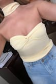 I ordered my usual size Small and it fits snug, even without a bra, but not so tight that I'd size up. The twist-front/bust section runs small and needs a little adjusting to get the cups to lay right, but overall, a super cute top for summer. - Mallory C.