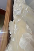 I like the dress and it's very fun, but it doesn't feel quite like the photos. It's definitely is more yellow than pictured. The waistband is really scratchy from the tulle, and the flowers aren't sewn on well (will have to fix this myself). I like it, and I'm keeping it for my wedding since I don't have time to find anything else, but I don't think it's worth the price considering the flaws and it's not shown very accurately. - Jordan M.