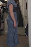 This dress is really pretty on the model, but the fabric bunches up along the zipper as well as a bunch in the back right where the zipper ends, which is very unflattering. It made me worried the dress was going to rip if I sat down. Didn't even end up wearing it to the wedding I purchased it for because I found a hole in the butt right before I was supposed to leave. Disappointed. - Maddie L.